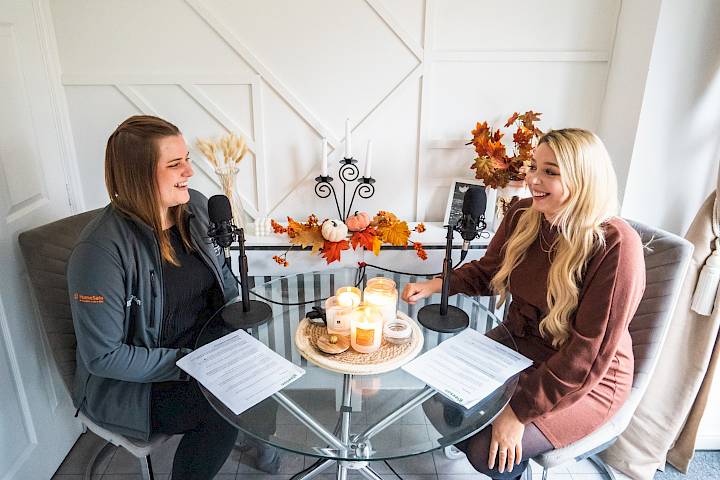 Host and guest laughing at the kitchen table