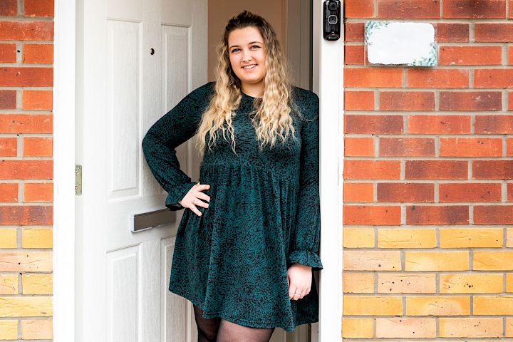 Woman standing in her doorway