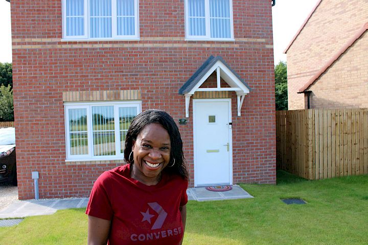 Lady laughing outside home