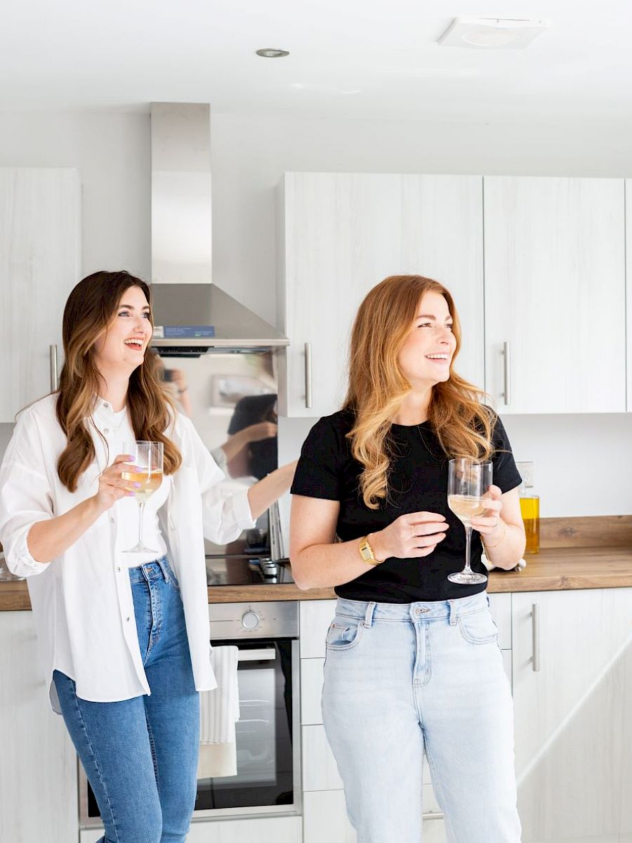 Three happy adults in a kitchen